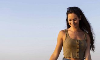 front-view-smiley-woman-outdoors-sun-with-copy-space